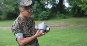 CWO2 Justin Trejo displays a 3D printed headcap for a rocket motor used to employ a M58 Mine Clearing Line Charge. Photo via Tonya Smith/US Marine Corps.