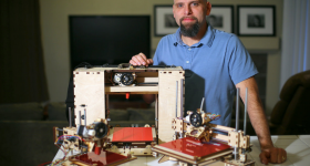 Brook Drumm and some early 3D printers. Photo via Printrbot.