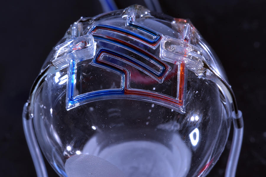 特色图像显示了一个研究人员的3D打印微流体设备。通过学院的照片。