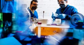 奈尔乔希,副教授化学和chemical biology, and Avinash Manjula-Basavanna, a postdoctoral researcher, work on programmable microbial ink for 3D printing of living materials, in the Mugar Life Sciences building. Photo by Matthew Modoono/Northeastern University.