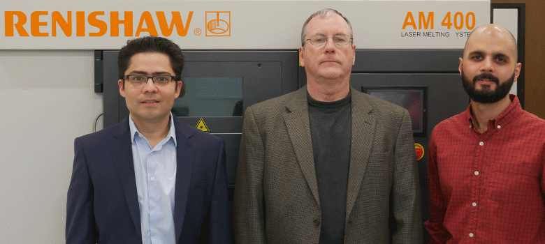 UTSAresearchers Arturo Montoya, Harry Millwater and David Restrepo stand in front of the Renishaw 3D printer at the Makerspace in the Science and Engineering Building. Photo via UTSA.